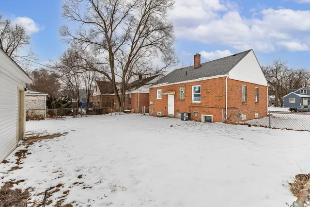 a view of a house with snow on the road