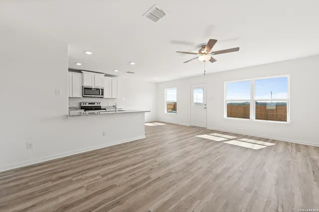 a view of kitchen with granite countertop cabinets and wooden floor