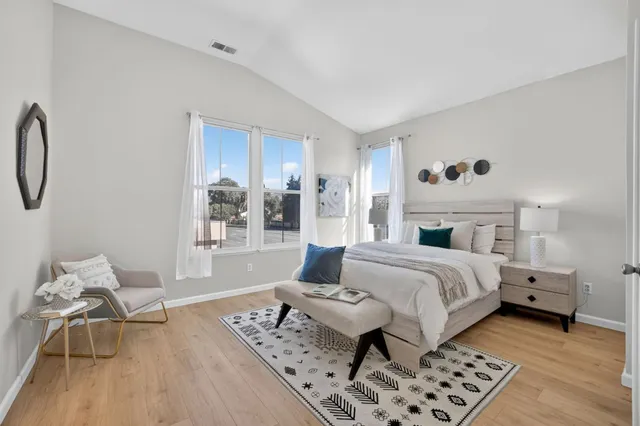 a bedroom with a bed and wooden floor
