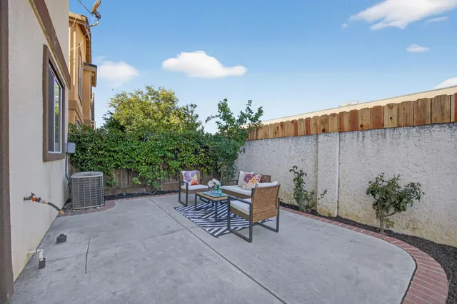 a backyard of a house with table and chairs