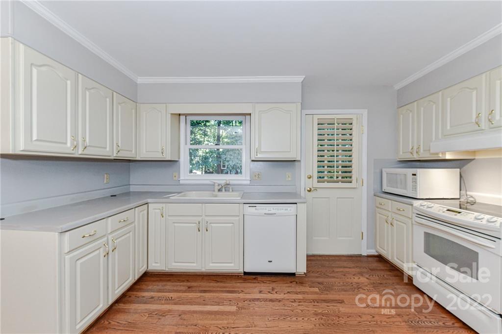 1231 Reverdy Lane, Unit 32 Matthews, NC 28105 - Photo 26 of 39 a kitchen with granite countertop white cabinets and white appliances