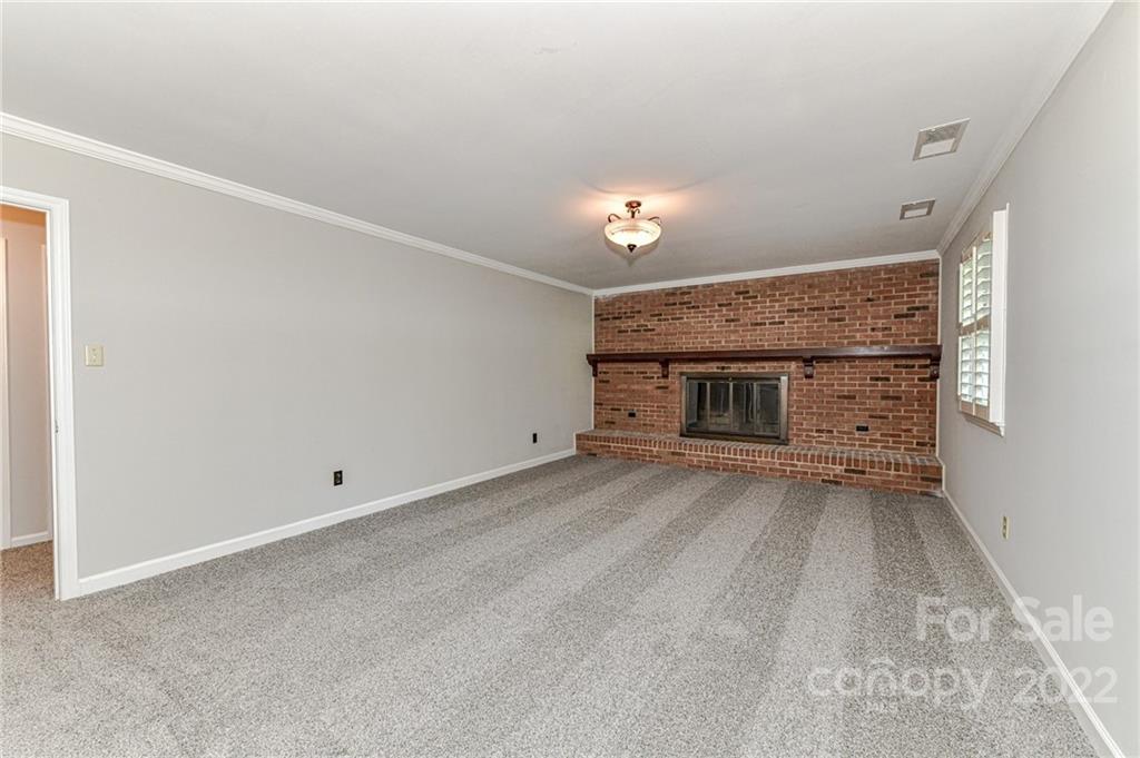 1231 Reverdy Lane, Unit 32 Matthews, NC 28105 - Photo 27 of 39 a view of an empty room with a fireplace and a window