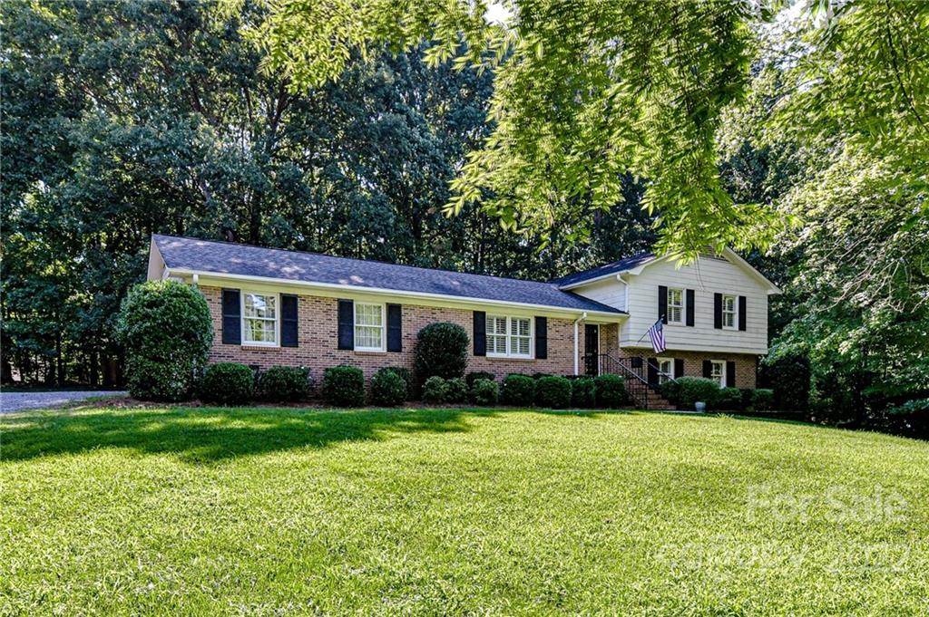 1231 Reverdy Lane, Unit 32 Matthews, NC 28105 - Photo 3 of 39 a front view of a house with garden