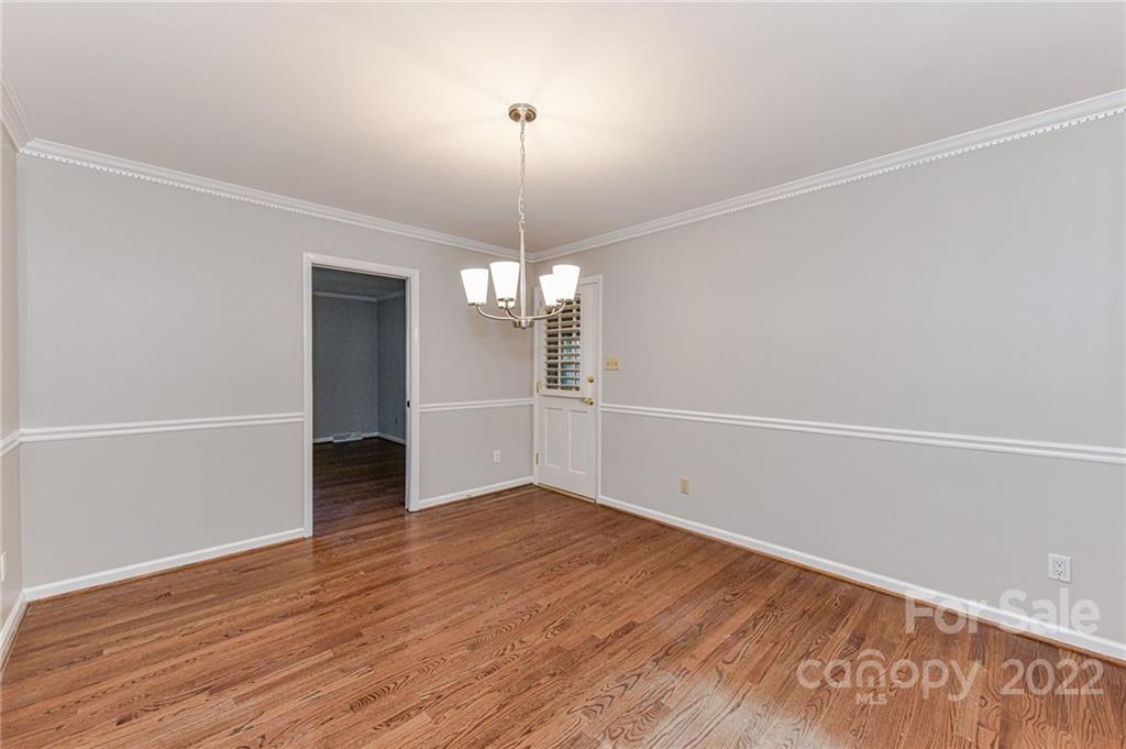 1231 Reverdy Lane, Unit 32 Matthews, NC 28105 - Photo 34 of 39 wooden floor in an empty room with a window