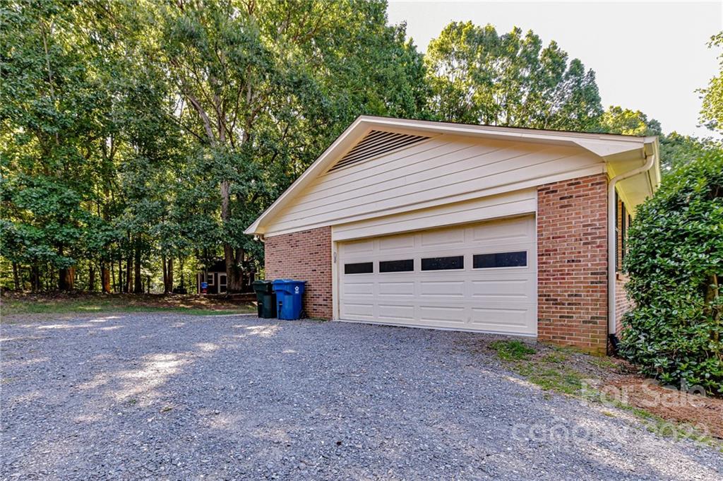 1231 Reverdy Lane, Unit 32 Matthews, NC 28105 - Photo 7 of 39 a view of a house with a yard and garage