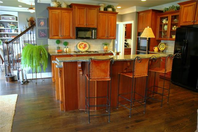 1226 White Rock Road Spring Hill, TN 37174 - Photo 7 of 20 a kitchen with stainless steel appliances granite countertop a refrigerator a stove a sink dishwasher and cabinets with wooden floor