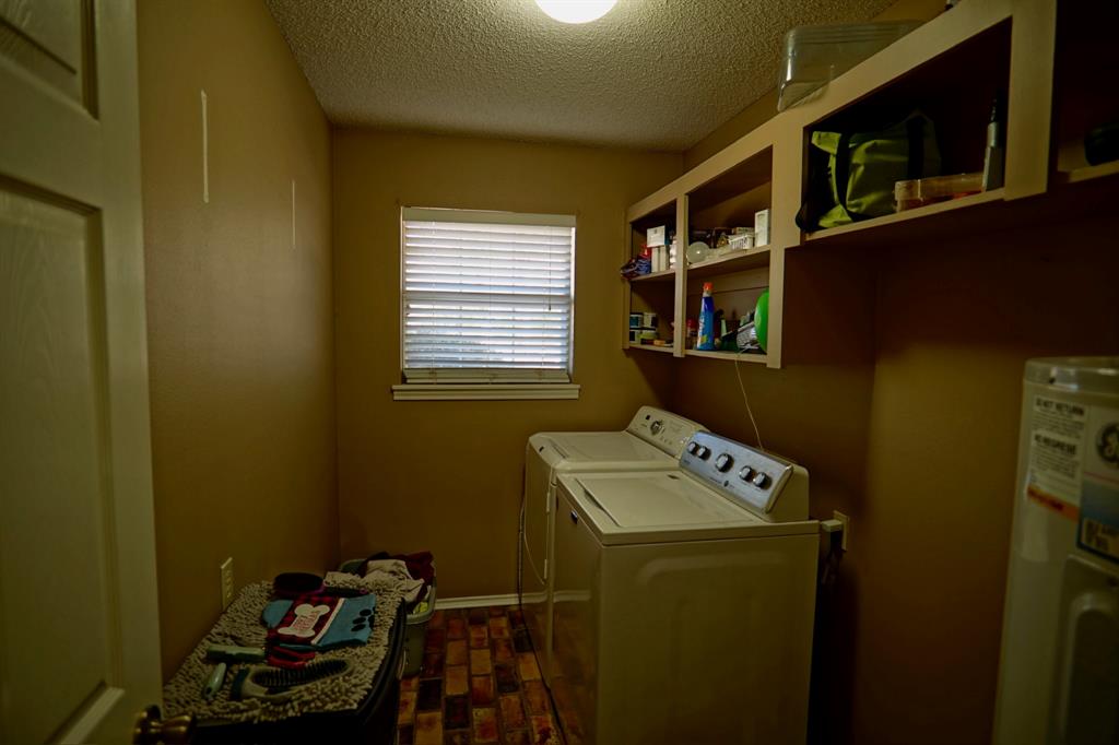 152 County Road Blossom, TX 75416 - Photo 15 of 21 a utility room with dryer washer and a view of living area