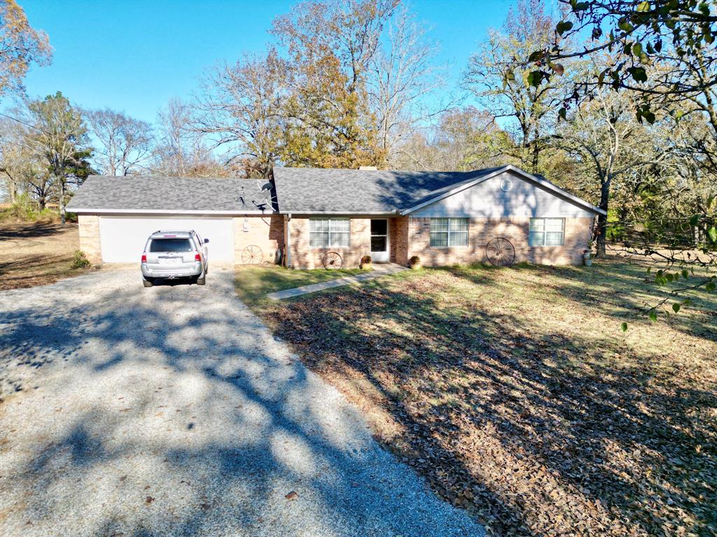 152 County Road Blossom, TX 75416 - Photo 2 of 21 a view of a house with a yard and large tree