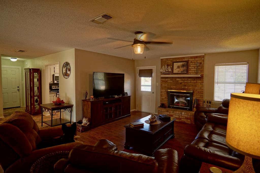 152 County Road Blossom, TX 75416 - Photo 3 of 21 a living room with furniture a flat screen tv and a fireplace