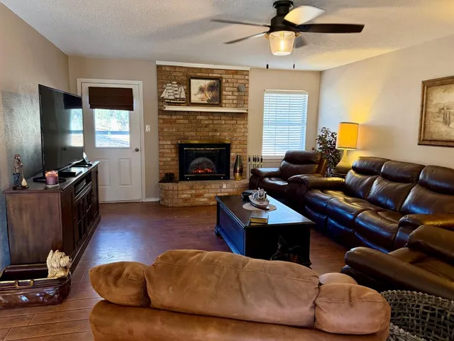 a living room with furniture fireplace and flat screen tv