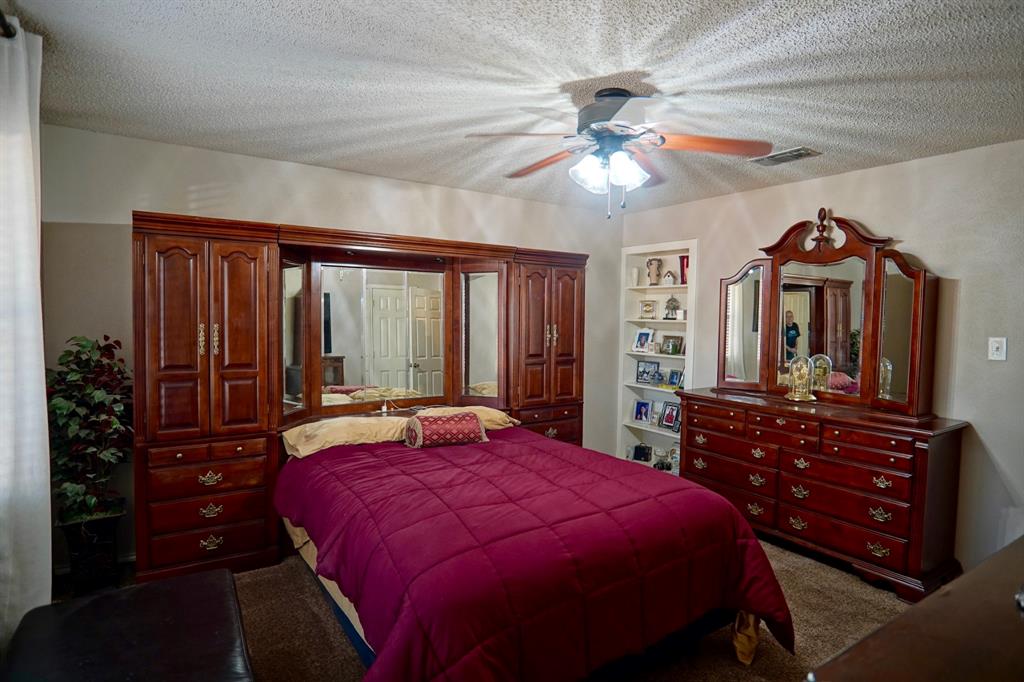 152 County Road Blossom, TX 75416 - Photo 9 of 21 a bedroom with a bed and a chandelier