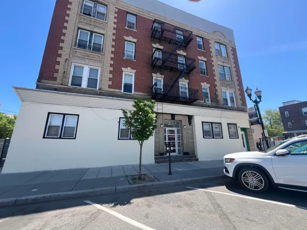 a front view of a house with parking space