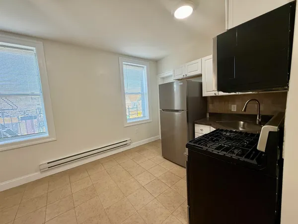 a kitchen with a refrigerator and a stove