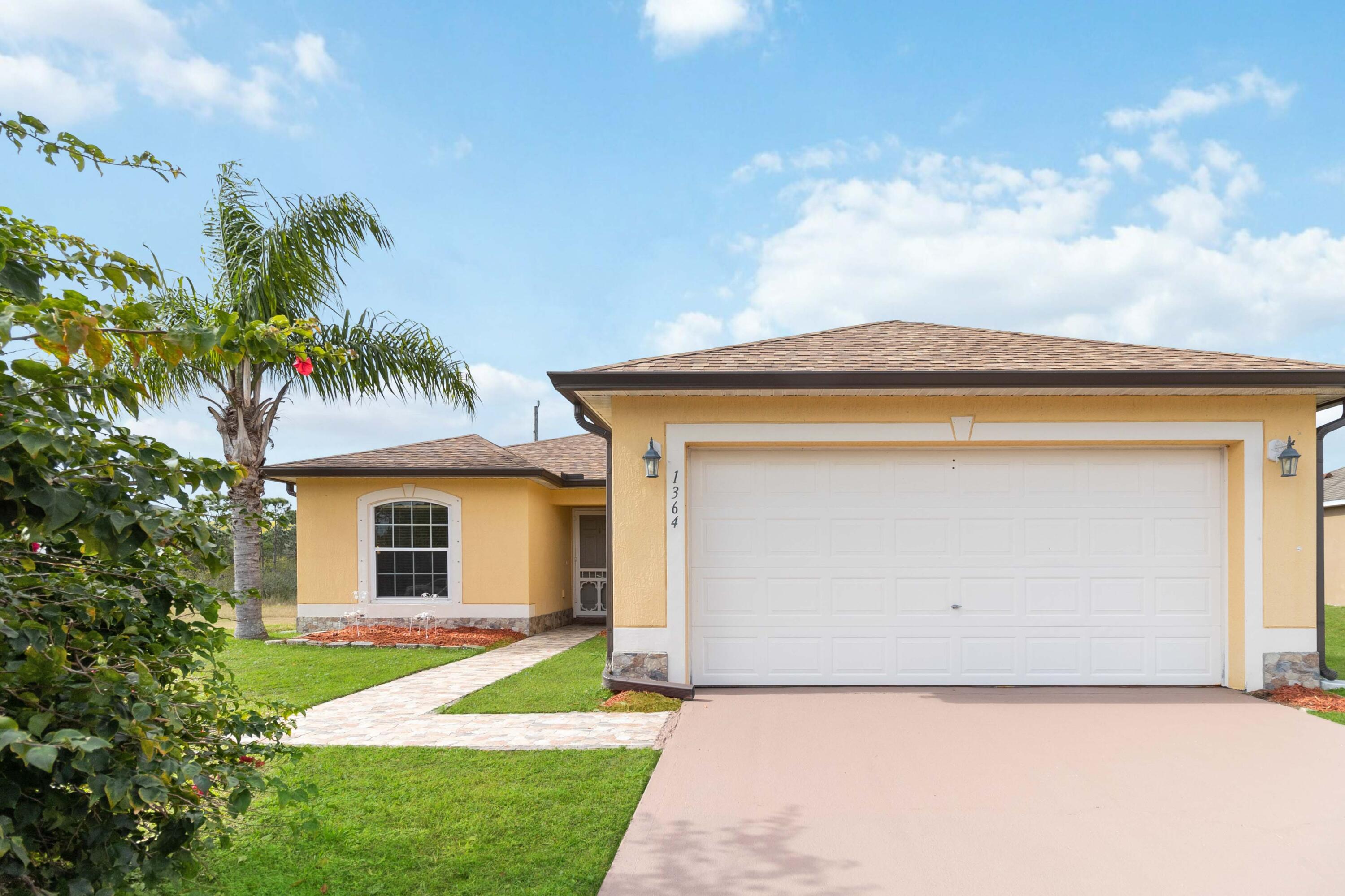 1364 Ran Road Southeast Palm Bay, FL 32909 - Photo 2 of 26 a view of a house with a yard and a garage