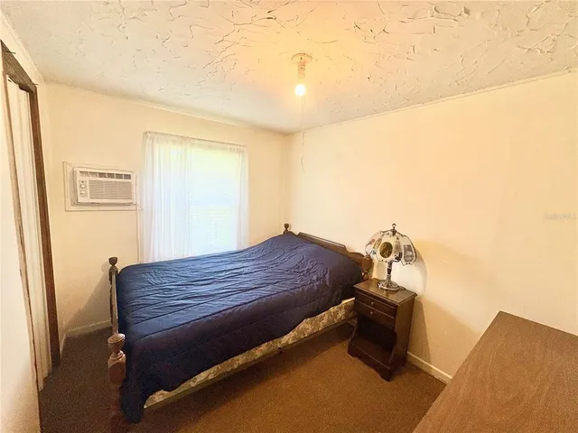 a bedroom with a bed and a mirror