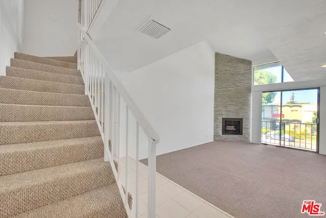 a view of an empty room with stairs