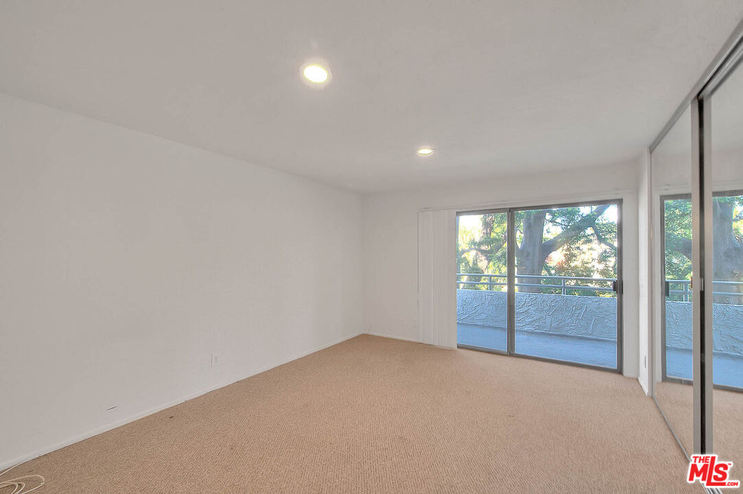 4311 Colfax Avenue, Unit 215 Studio City, CA 91604 - Photo 3 of 8 an empty room with wooden floor and windows
