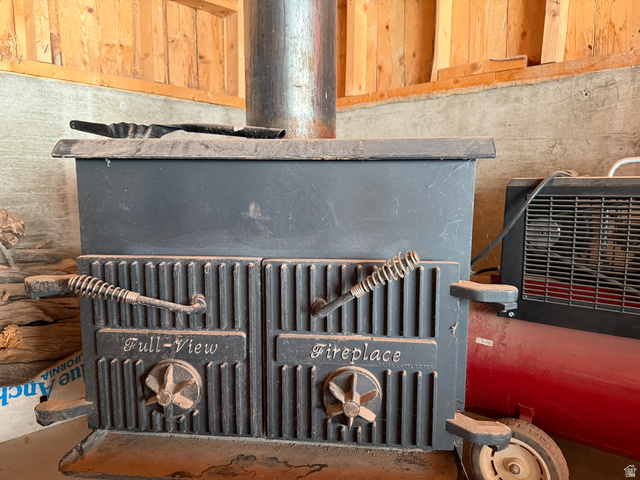 358 South Sky Drive Torrey, UT 84775 - Photo 44 of 82 Cast iron wood-burning fireplace with a vertical flute door design, spring-wrapped handle, and adjustable air vents