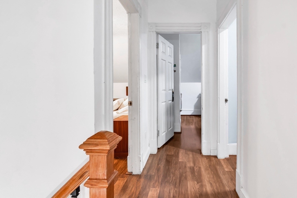 42 D Street Lowell, MA 01851 - Photo 22 of 27 a view of a hallway with wooden floor and a bathroom
