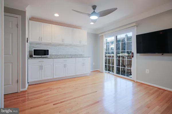 a view of a kitchen with dishwasher and a flat screen tv