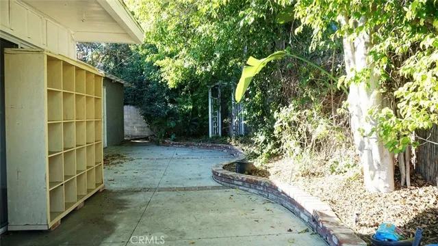 a view of a house with a tree in the yard