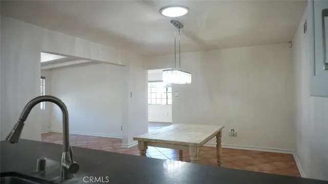 a kitchen with granite countertop a sink stove and refrigerator