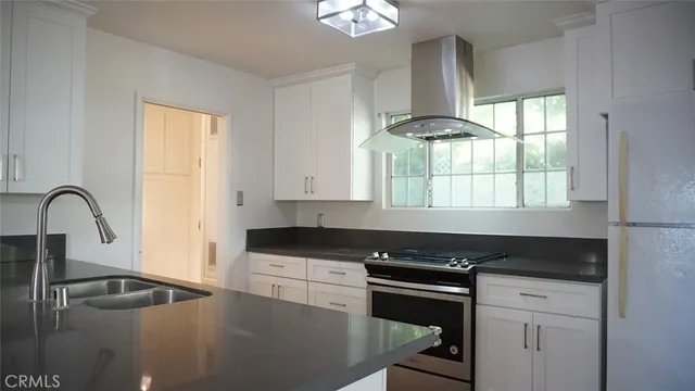a view of a hallway with wooden floor and a fireplace