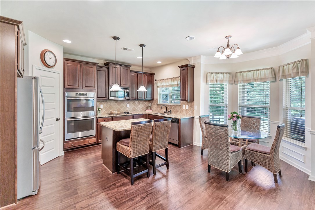 144 Buckland Drive Anderson, SC 29621 - Photo 31 of 48 A well-appointed culinary space featuring rich wood cabinetry, granite countertops, and modern stainless steel appliances.