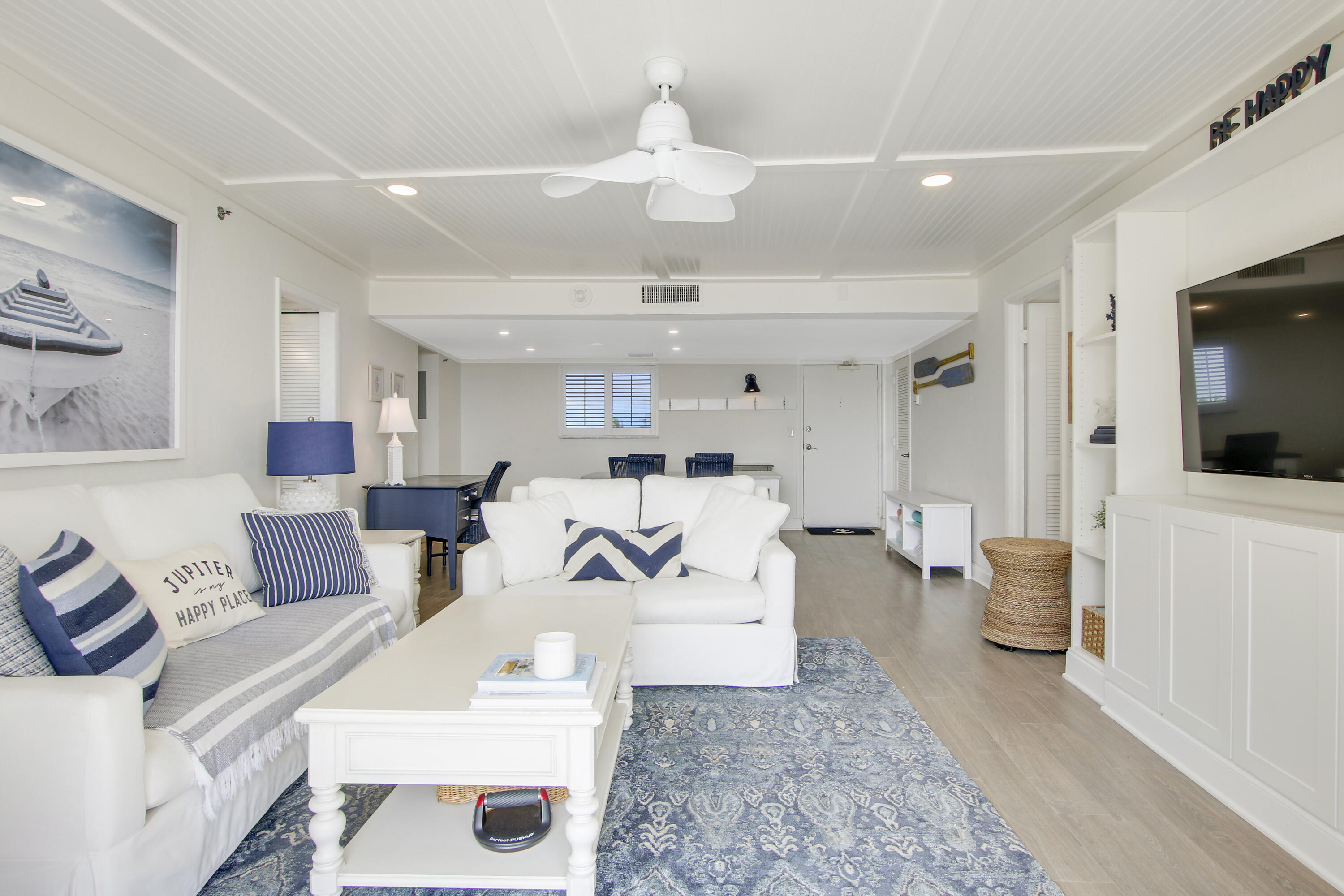 200 Ocean Trail Way, Unit 105 Jupiter, FL 33477 - Photo 18 of 22 a living room with furniture and a flat screen tv