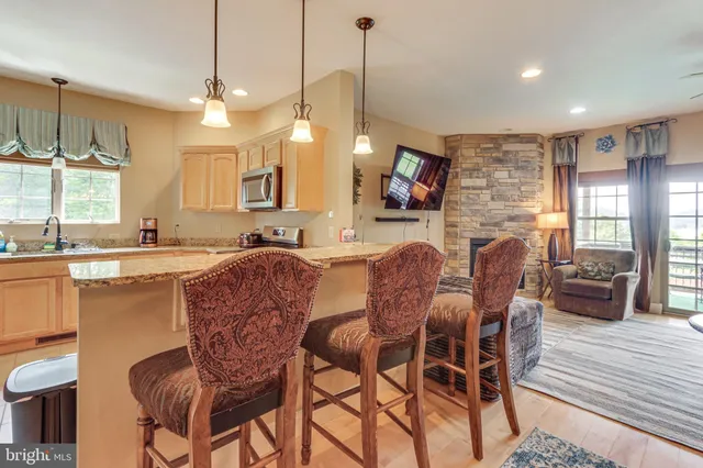 a dining room with furniture a window and kitchen view