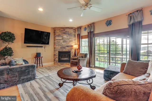 a living room with furniture a flat screen tv and a large window
