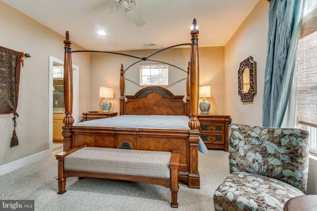 a living room with furniture a bed and a flat screen tv