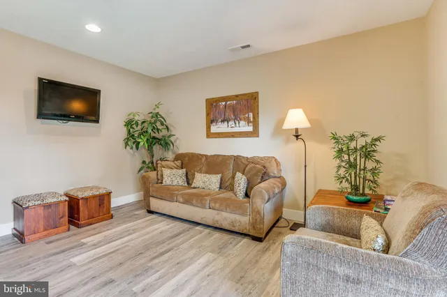 a room with furniture pool table and window