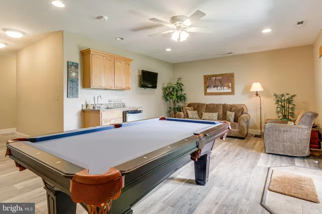 a living room with furniture a table and a large window