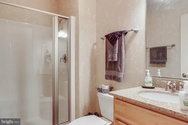 a bathroom with a sink a mirror and shower