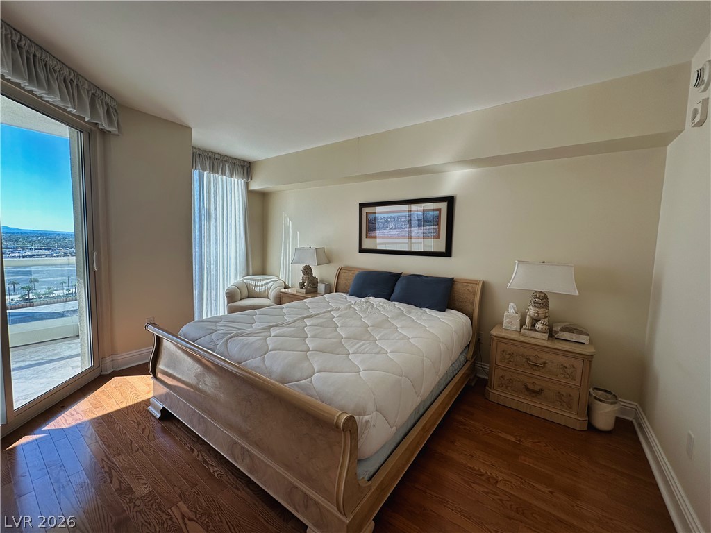 2747 Paradise Road, Unit 1706 Las Vegas, NV 89109 - Photo 17 of 35 Hardwood flooring extends throughout this naturally illuminated bedroom with direct access to an outdoor balcony.