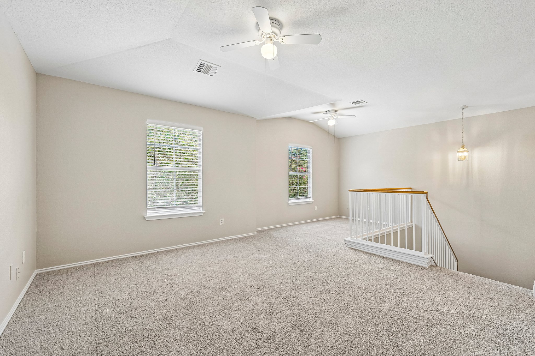 616 Scheel Road Kyle, TX 78640 - Photo 17 of 39 A spacious upper-level area offers soft carpeting and two bright windows.