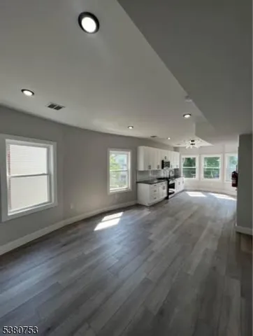 an empty room with a empty space and windows