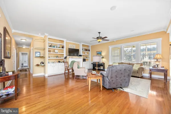 a dining room with furniture a chandelier and wooden floor