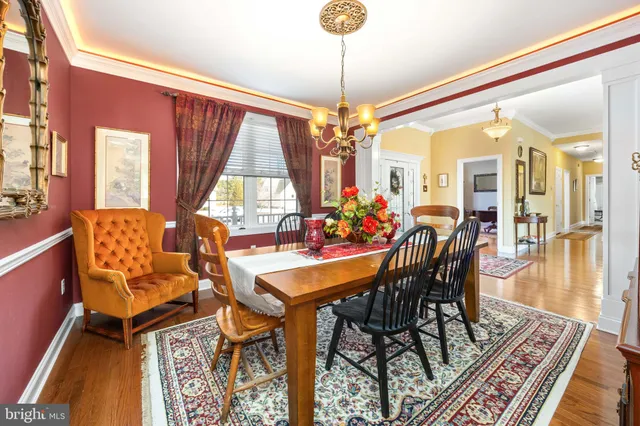 a living room with furniture chandelier and a large window