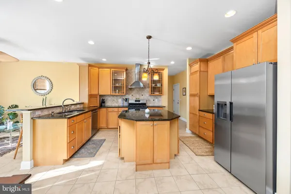 a bedroom with a bed and dresser with mirror