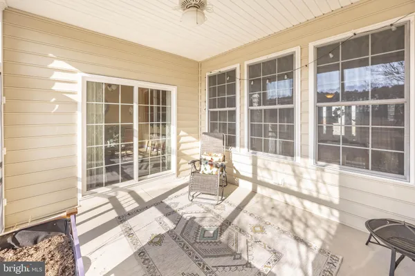 a room with a baby crib furniture and a window