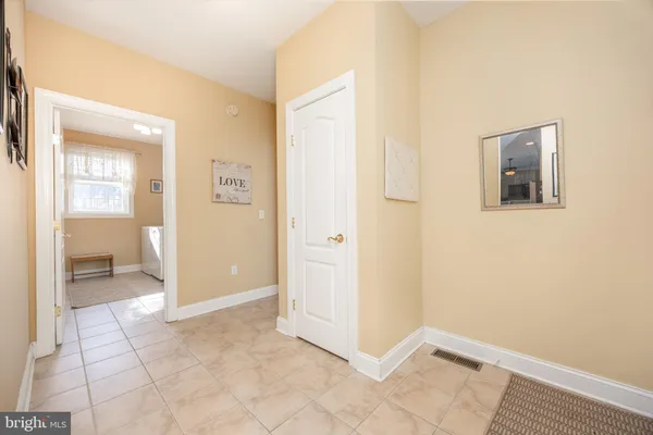a living room with a bed furniture and a ceiling fan