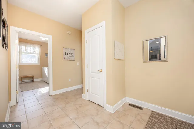 a living room with a bed furniture and a ceiling fan