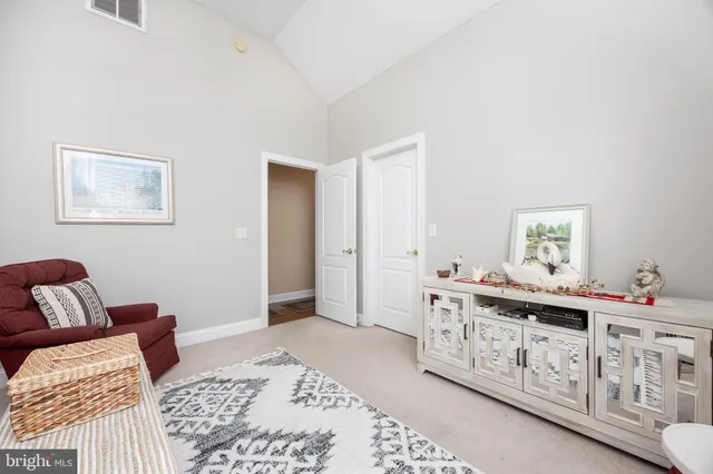 a view of a house with a yard and large tree