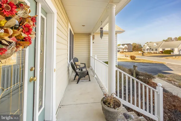 a living room with fireplace furniture and a large window