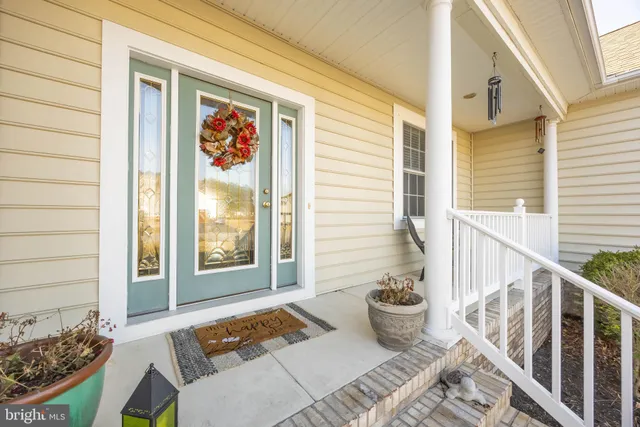 a living room with fireplace furniture and a large window
