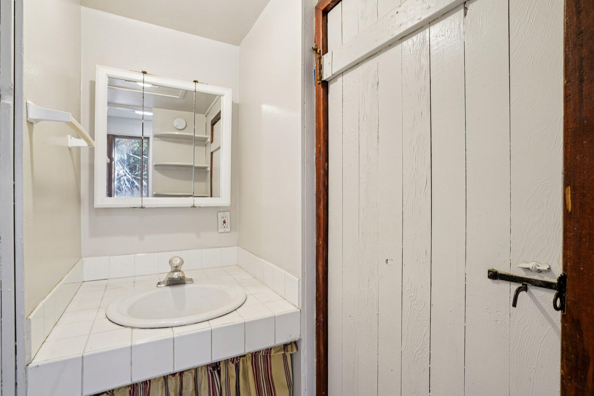 53451 Middleridge Drive Idyllwild, CA 92549 - Photo 19 of 29 a bathroom with a sink and a mirror