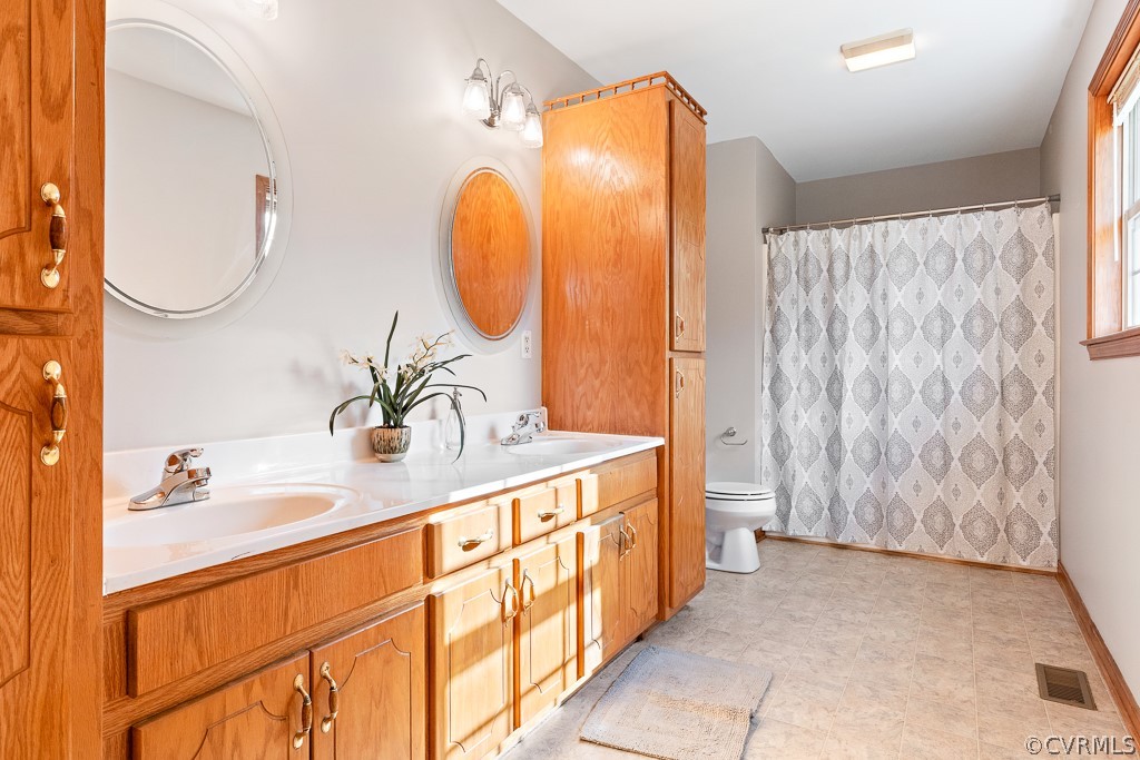 19160 Halifax Road Carson, VA 23830 - Photo 23 of 30 a bathroom with a double vanity sink mirror and shower