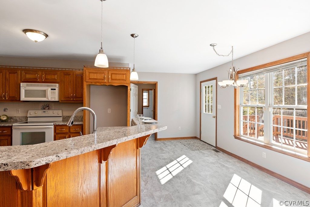 19160 Halifax Road Carson, VA 23830 - Photo 10 of 30 a kitchen with granite countertop a stove a sink and a refrigerator
